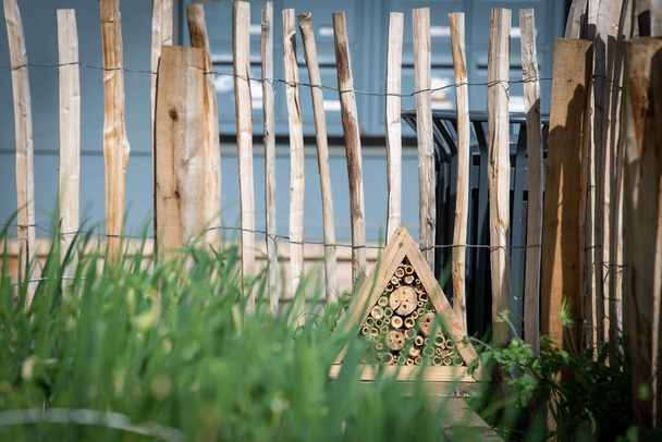 An insect shelter has been installed on the corner of the roof of a hut near an urban vegetable farm - Fotoğraf, Görsel