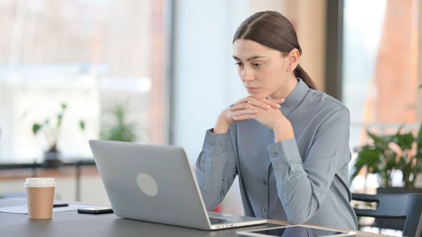 Latin Woman Thinking while using Laptop at Work  - Fotó, kép