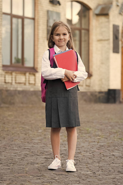 Small kid with back to school look carry backpack holding books, homework - Foto, Bild