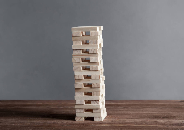 Tower from wooden blocks standing on table - Foto, Imagen