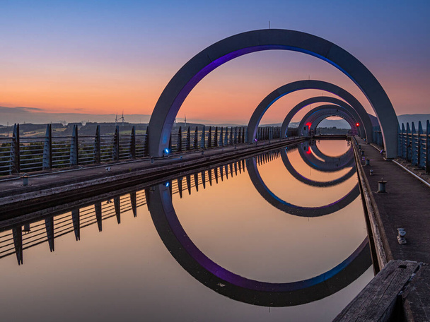 The canal leading to the top of the Falkirk Wheel. The Falkirk Wheel is a rotating boat lift in Scotland connecting the Forth and Clyde Canal with the Union Canal. - Photo, Image