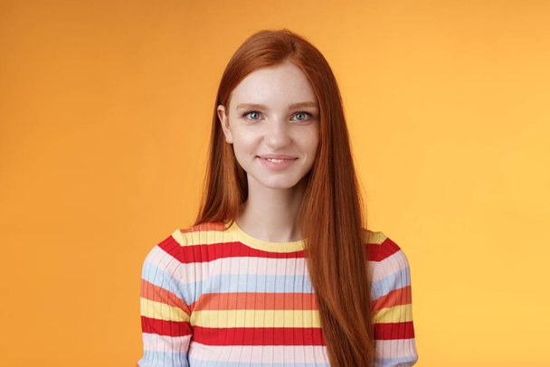 Pleasant friendly-looking confident smart redhead female student aim success smiling self-assured express lucky positive upbeat mood casually hang out orange background listening amusing story - Fotó, kép