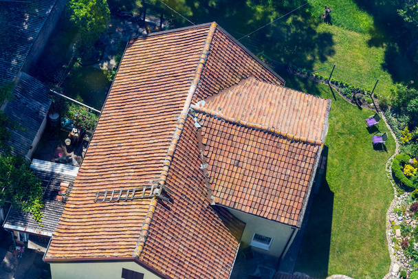 Evin metal kiremit çatısının kuş bakışı görüntüsü. Eski bir evin mimarisi kavramı.. - Fotoğraf, Görsel