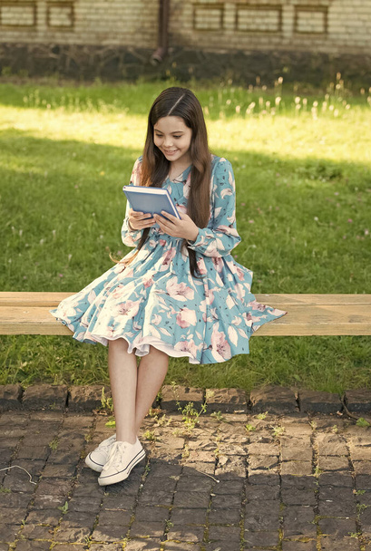 Child girl relaxing outdoors with book, reading fairy tale concept - Φωτογραφία, εικόνα