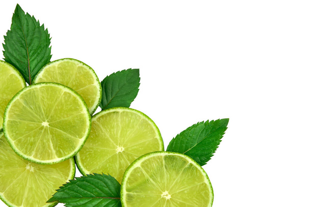 Lime slices and mint leaves isolated on white background, top view. - Fotografie, Obrázek