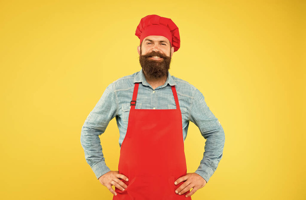 mature male chef on yellow backdrop. man cooking on kitchen. Professional chef man excited and smiling. excellent cook or baker. special offer from chef. chef in restaurant kitchen. Excellence - Valokuva, kuva