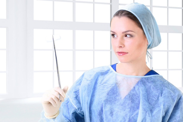 Young working beautiful woman doctor in uniform - 写真・画像