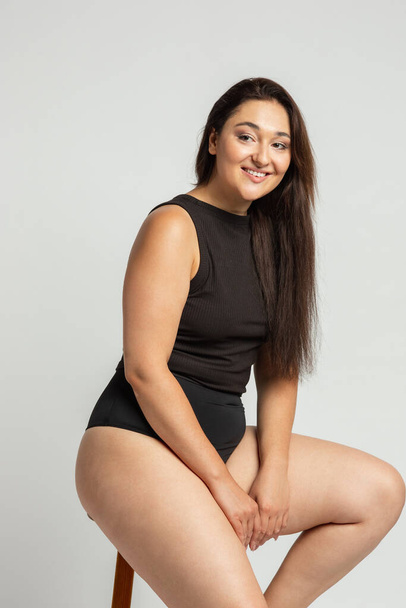 Young beautiful plump woman in cotton underwear on white background - Photo, Image