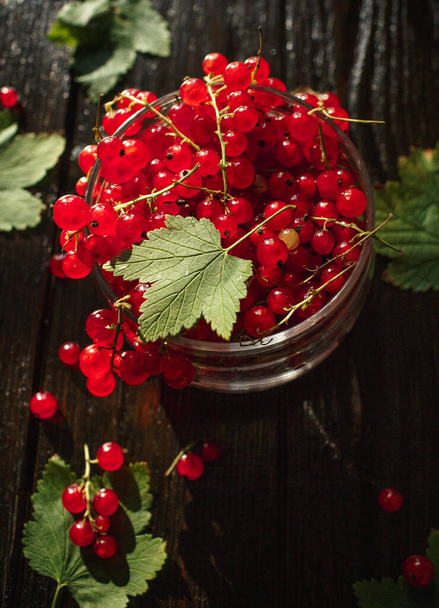 red currant, berry on a wooden table, wooden background - Photo, image