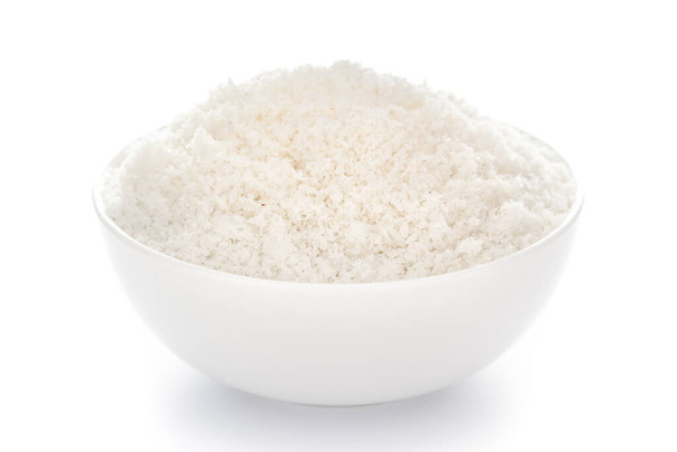 Zbliżenie białego suchego, wysuszonego organicznego kokosa w białej ceramicznej misce na białym tle. - Zdjęcie, obraz