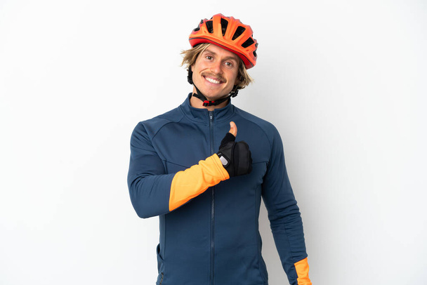 Young blonde cyclist man isolated on white background giving a thumbs up gesture - Foto, Bild