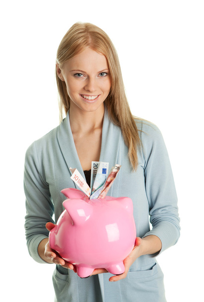 Beautiful young woman saving money - Фото, изображение
