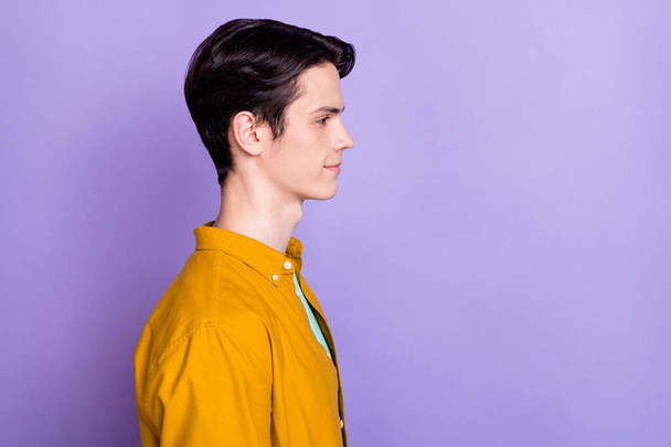 Profile side photo of young handsome man happy positive smile confident look empty space isolated over violet color background - Foto, afbeelding