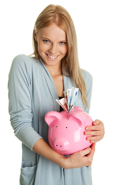Beautiful young woman saving money - Photo, image