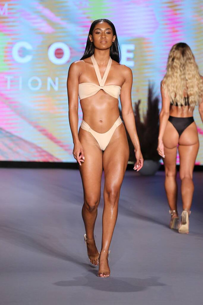 MIAMI BEACH, FLORIDA - JULY 09: A model walks the runway as Oh Polly Launch New Swimwear Brand Neena Swim For Miami Swim Week Paraiso Miami Beach at The Paraiso Tent on July 09, 2021 in Miami Beach, Florida. - Fotografie, Obrázek