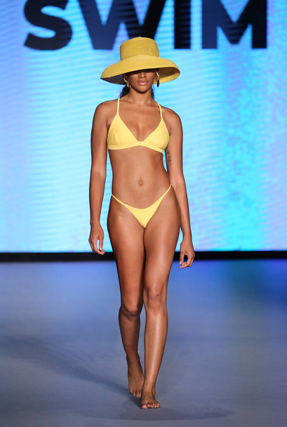 MIAMI BEACH, FLORIDA - JULY 10:  A model walks the runway during Life by Style Group Collective: Avid Swim Show for Miami Swim Fashion Week at Paraiso Miami Beach at The Paraiso Tent on July 10, 2021 in Miami Beach, Florida. - Photo, Image