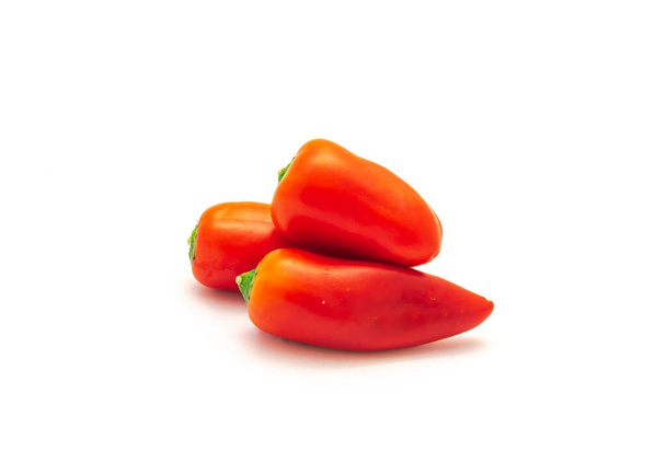 Three vibrant red mini sweet peppers isolate on white background. Tiny mini snack peppers are sweeter than average bell pepper. - Photo, Image