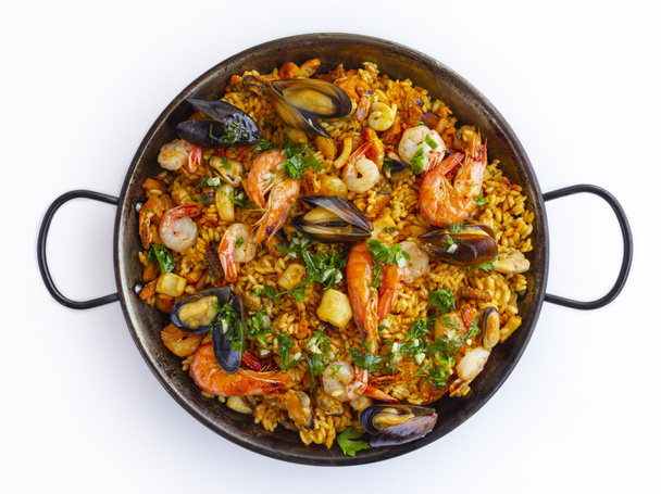 Traditional spanish seafood paella in the fry pan on a white background - Photo, Image