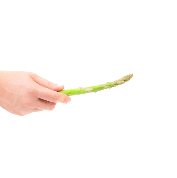 Hand holding green asparagus. - Foto, imagen