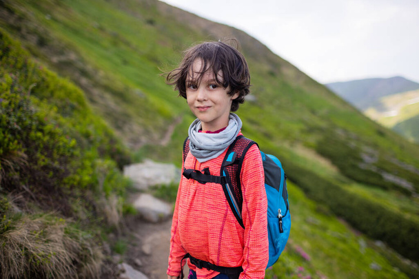portrait of a boy with a backpack during a hike. children's outdoor recreation. - Photo, Image