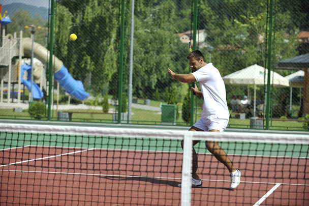 Young man play tennis outdoor - 写真・画像