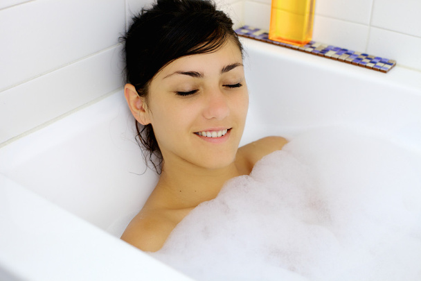 Young woman relaxing taking a bath - Foto, Imagem