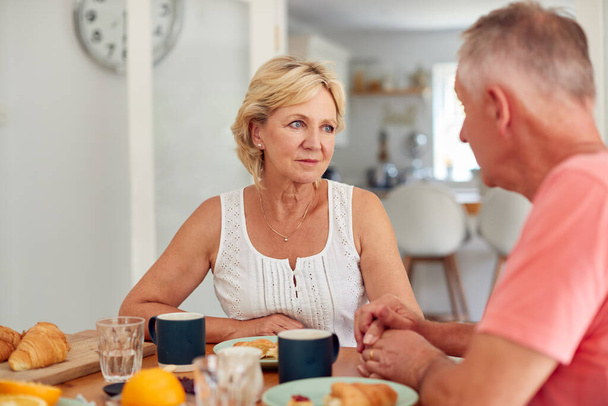 Senior Man Comforting Woman Suffering With Depression At Breakfast Table At Home - Valokuva, kuva