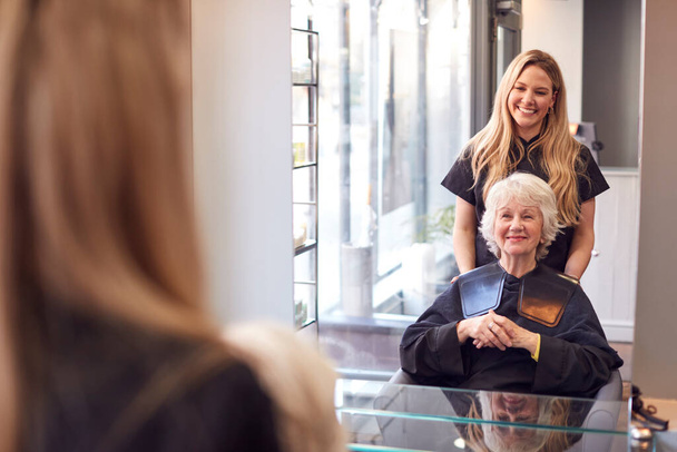 Senior Woman Having Hair Cut By Female Stylist In Hairdressing Salon - Photo, Image