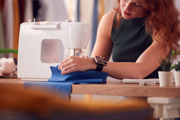 Close Up Of Female Student Or Business Owner Working In Fashion Using Sewing Machine In Studio - 写真・画像