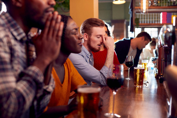 Group Of Disappointed Customers In Sports Bar Watching Sporting Event On Television - Fotoğraf, Görsel