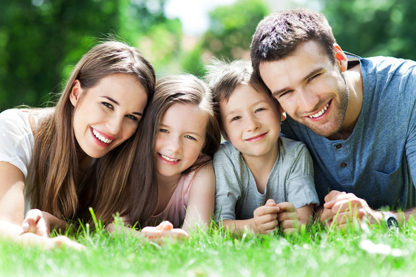 Family outdoors lying on grass - Photo, Image