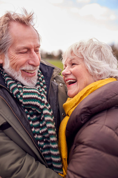 Close Up Of Loving Senior Couple Enjoying Autumn Or Winter Walk Through Park Together - Photo, Image