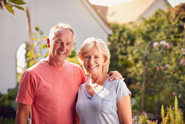 Portrait Of Loving Retired Couple Working In And Enjoying Summer Garden At Home - Valokuva, kuva
