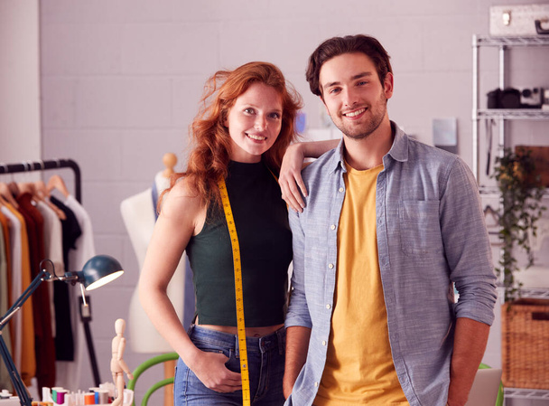 Portrait Of Male And Female Business Owners Standing Together In Fashion Studio - Photo, Image