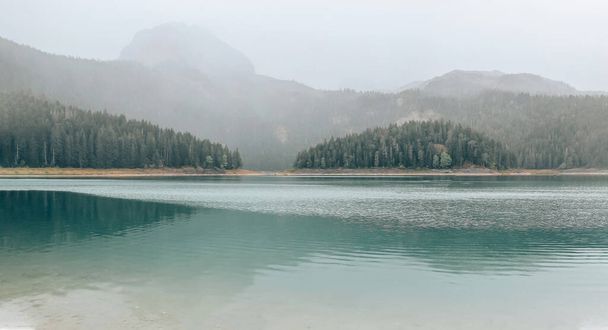 View of the Black Lake in Montenegro on Mount Durmidor in cloudy weather. Tourism and travel concept - Photo, Image