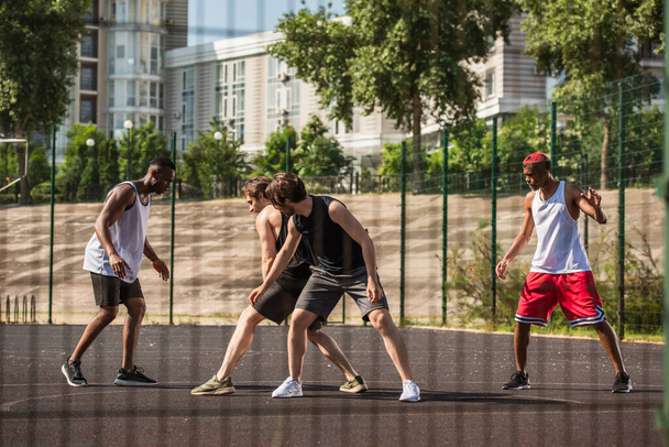 Interracial men training on playground outdoors  - Foto, Imagen