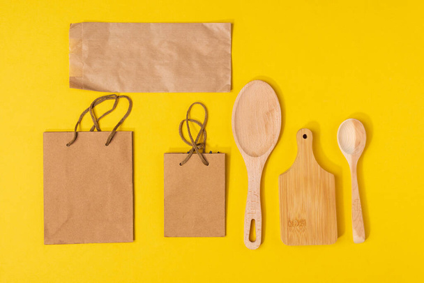 Zero waste eco friendly reusable objects such as reusable craft paper, wooden board spoon vs plastic single use objects. - Photo, Image