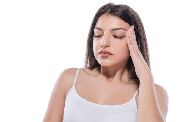 beautiful young woman with headache on white background - Fotó, kép