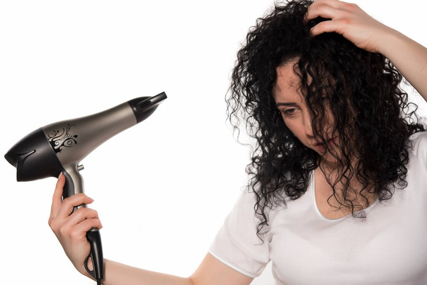 young woman with hairdryer on white background - Photo, Image