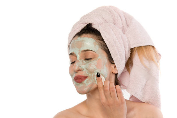 young woman with facial mask on her face - Photo, Image
