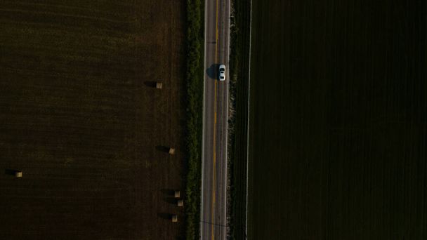 Ein Blick aus der Vogelperspektive auf eine leere Straße, die neben dem Feld liegt. - Foto, Bild