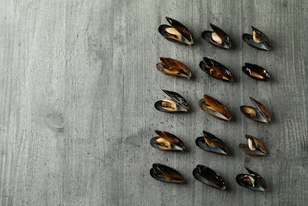 Fresh mussels on gray textured background, space for text - Fotó, kép
