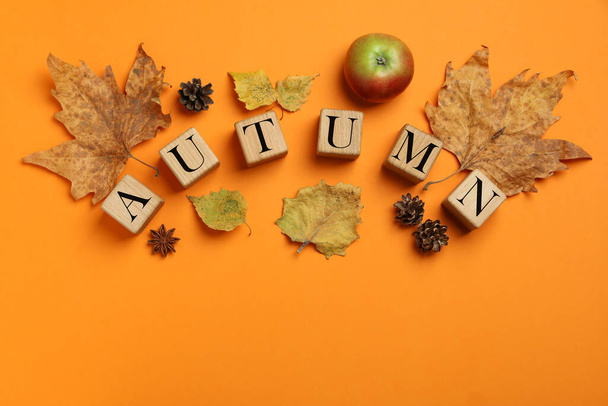 Cozy autumn concept on orange background, top view - Фото, зображення