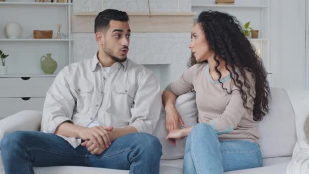 Worried hispanic spaniard couple offended frustrated with quarrel arguing about breaking up or divorce shout loud sitting on couch misunderstanding having problems in difficult relationships conflict - Footage, Video
