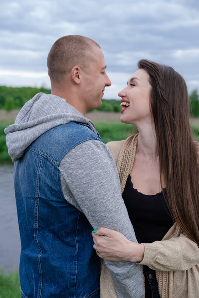 fashionable young couple outdoors. bald man and brunette woman. husband and wife. millennials in trendy clothes - jeans - Zdjęcie, obraz