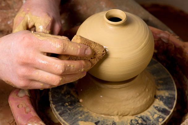 hands of a potter, creating an earthen jar - Photo, Image
