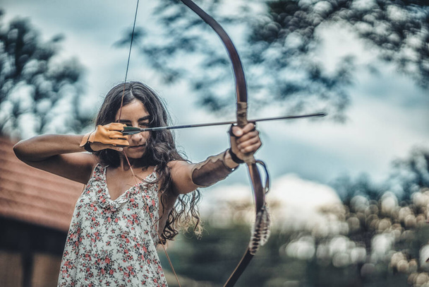 detail of a woman training shooting with a bow. - Photo, Image