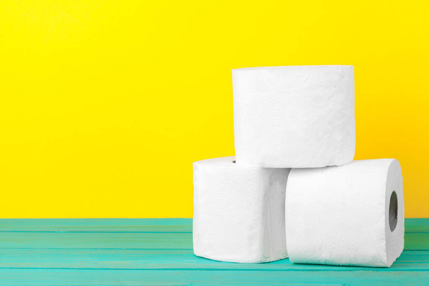 Toilet paper stacks on bright yellow background - Photo, Image