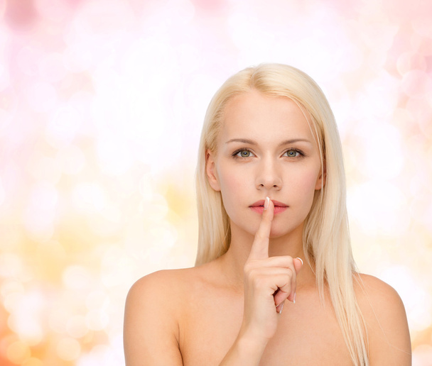calm young woman with finger on lips - Foto, Imagen