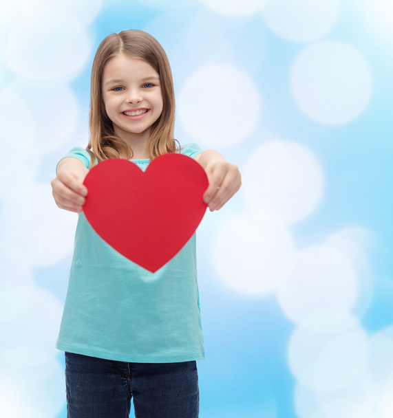 smiling little girl giving red heart - Фото, зображення